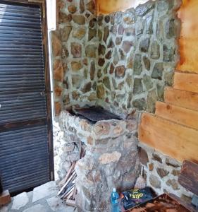 a stone wall with a stone stove in a room at Popović na Drini in Bajina Bašta