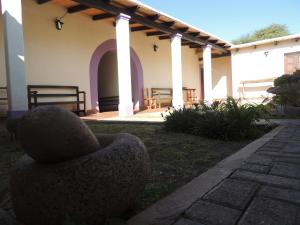 a stone chair sitting outside of a building at El Rancho de Manolo in Molinos