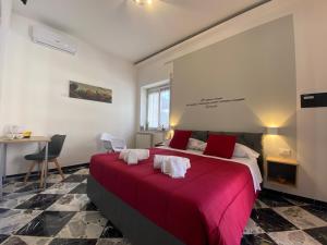 a bedroom with a large bed with a red blanket at Al Teatro Greco in Syracuse