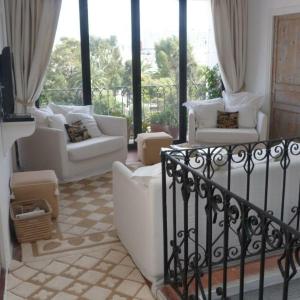 a living room with white couches and windows at SUMMER HOUSE TANGER in Tangier