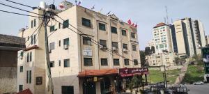 an old building on the side of a city street at Eco Hostel in Ramallah