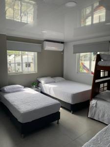 two beds in a room with two bunk beds at Summer Breeze in San Andrés