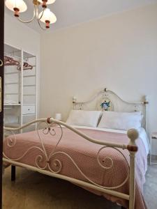 a bedroom with a white bed with a red blanket at Casa Bianca B&B in Ostuni