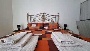a bedroom with a large bed with two pillows at Casa Bianca B&B in Ostuni +49 photos