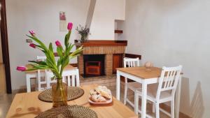 a dining room with a table and chairs and a fireplace at Casa Bianca B&B in Ostuni