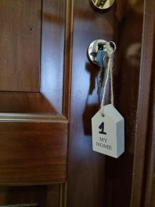 a door lock with a key on it with a my home tag at Casa Bianca B&B in Ostuni