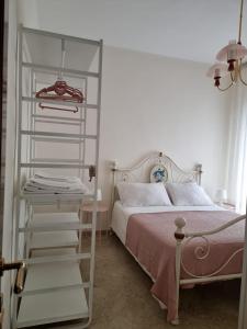 a bedroom with a bed and a white book shelf at Casa Bianca B&B in Ostuni
