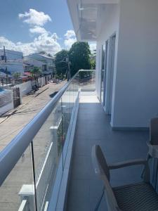 a balcony of a building with a chair on it at Summer Breeze in San Andrés