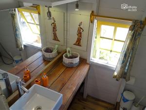 a bathroom with a sink and a wooden counter at Cabañas Techarí in Punta Del Diablo