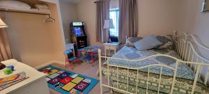 a childs bedroom with a bed and a video game at Hidden Gem 2 bed 2 bath private mobile home with great parking in Fernley