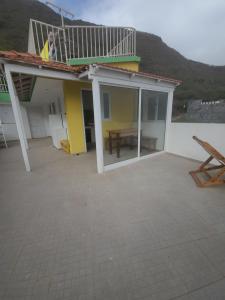 a patio with a deck on top of a house at LA MENOR in Ribeira Grande