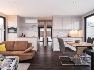 a kitchen and living room with a couch and a table at Houseboat with Stunning Views in Sneek