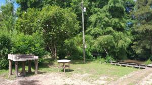 a park with a table and a street light at Cabañas Al Río Delta Tigre in Tigre