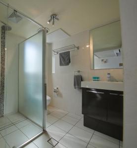 a bathroom with a shower and a sink at Tuncurry Motor Lodge in Tuncurry
