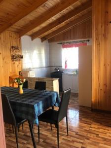 a kitchen with a table and chairs in a room at Cabañas Terra Nova Colbun Machicura in Linares