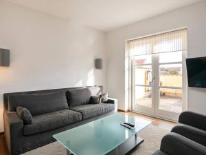 a living room with a couch and a glass table at 6 person holiday home in Skagen-By Traum in Skagen