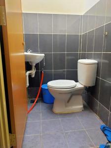 a bathroom with a toilet and a sink at AYUNI HOMESTAY KUALA BESUT TERENGGANU in Kuala Besut
