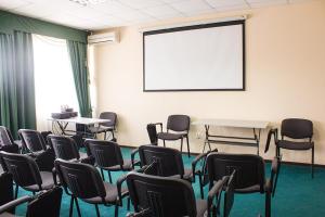 a room with chairs and a table and a whiteboard at Pyatigorsk Hotel in Pyatigorsk