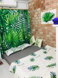two beds in a room with plants on the wall at Chicken's house- Đường Lâm Homestay in Hanoi