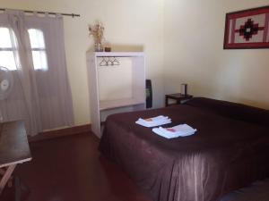 a bedroom with a bed with two towels on it at El Rancho de Manolo in Molinos