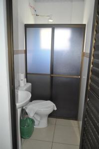 a bathroom with a toilet and a sink at Hotel Cataratas in Foz do Iguaçu