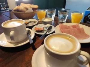 a table with a cup of coffee and a plate of food at El Rancho de Manolo in Molinos