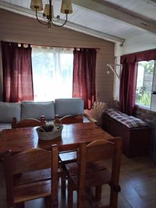 a living room with a wooden table and a couch at PORTAL DE LA ESTEPA in Dina Huapi