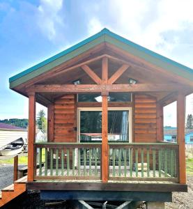 Cette cabane en rondins dispose d'une terrasse couverte et d'une grande fenêtre. dans l'établissement The Bogi Bear Inn, à Forks