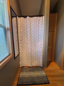 a shower door in a room next to a window at The Bogi Bear Inn in Forks