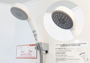 a white toilet with a shower head on a paper at APA Hotel Hakata Higashihieekimae in Fukuoka