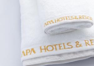 two towels with the words ra ni hotels and resorts on them at APA Hotel Hakata Higashihieekimae in Fukuoka