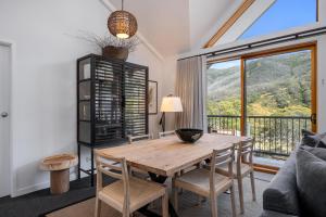 a living room with a table and chairs at Snowgoose Apartments in Thredbo