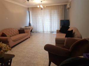 a living room with two couches and a television at 2 munites walk to Ladies Beach in Aydın