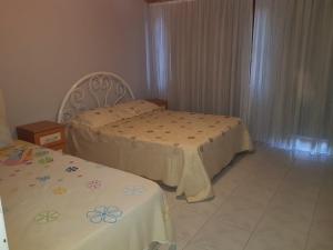 a bedroom with two beds and two tables in it at 2 munites walk to Ladies Beach in Aydın