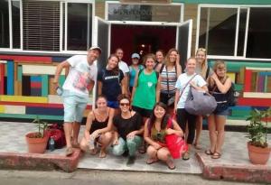 a group of people posing in front of a building at Twin Fin Plaza in Bocas del Toro