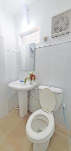 a white bathroom with a toilet and a sink at Dealings Freedom Rest in Gampola