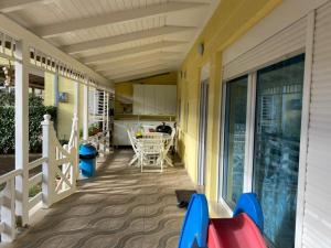 a porch with a table and chairs on a house at Villa Shera in Mullini i Danit