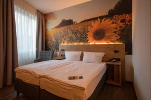 Postel nebo postele na pokoji v ubytování Hotel Stadt Aurich