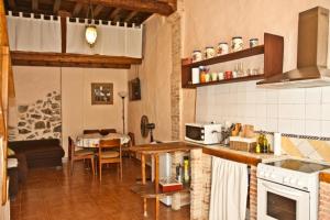 a kitchen with a table and a dining room at La Casa Mora in Jérica