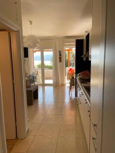 a kitchen with a tiled floor with a view of the ocean at Unique luxury beach house in Poros Island in Poros