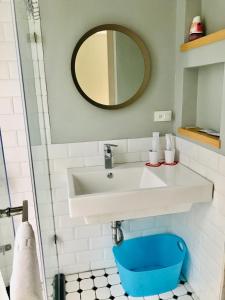 a bathroom with a white sink and a mirror at Yishan Village in Jincheng