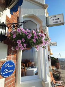a window of a house with pink flowers on it at Penn House Hotel in Weymouth