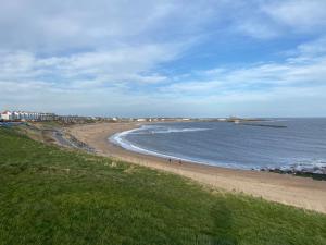 North SeatonにあるSandy bay mariners riseの砂浜と水上を歩く人々のいる浜 +6枚の写真