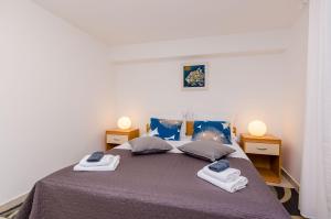a bedroom with a bed with two towels on it at Apartment Domix in Dubrovnik