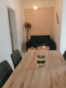 a wooden table in a living room with a couch at Apartman Marita in Kaštela