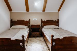 two twin beds in a room with a night stand at Holiday Home Na Biru 1 in Tolmin