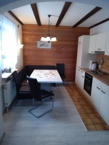 a kitchen and dining room with a table and chairs at Fewo Oehlenschlaeger Nr 53 Eg in Arrach