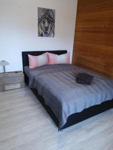 a bedroom with a large bed with pink pillows at Fewo Oehlenschlaeger Nr 53 Eg in Arrach
