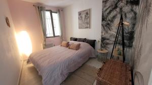 a bedroom with a bed and a lamp in it at vintage home in L'Isle-sur-la-Sorgue