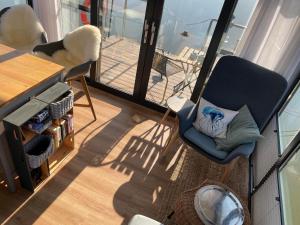 a room with two chairs and a table and a balcony at Hausboot Schwanennest in Kirchberg an der Raab